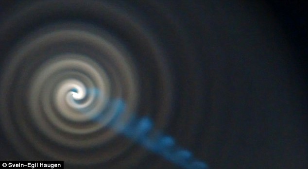 Curious: A blue-green beam of light was reported to have come shooting out the centre of the spiral 